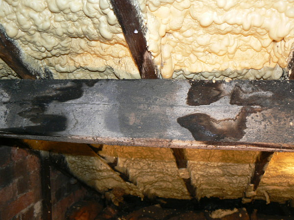 Image of foam spray below old clay tiles.