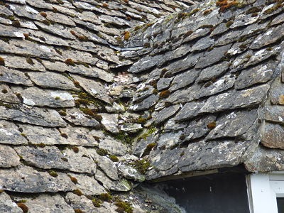 Image of a roof being re-roofed in stone slates.